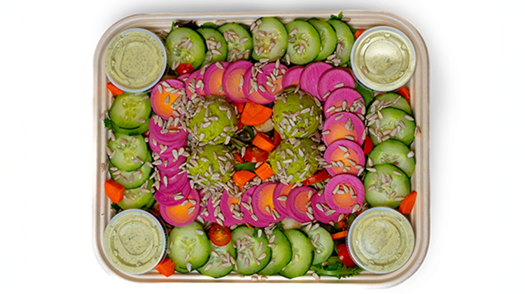 A colorful Vitality Bowls catering tray with fresh vegetables and greens